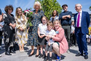 Queen Camilla and authors with staff and pupils from school